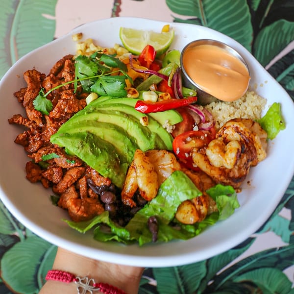 A Lo Fresco's healthy bowl with steak, shrimp, avocado, quinoa, and vegetables.